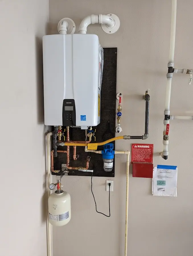 Professional plumber installing copper piping in a Columbia Falls home